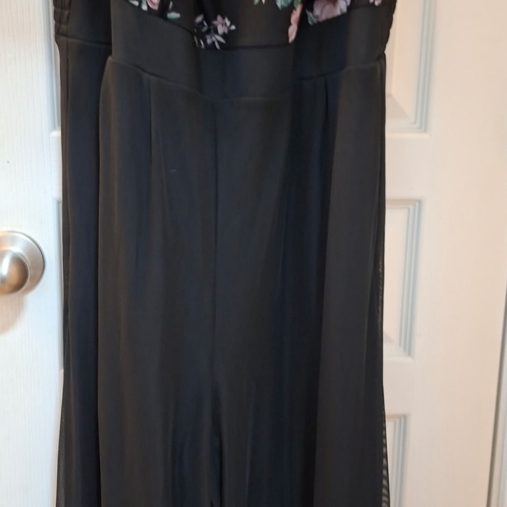 This is a Torrid black floral wide leg challis jumpsuit with a mesh overlay on t - Picture 4 of 5